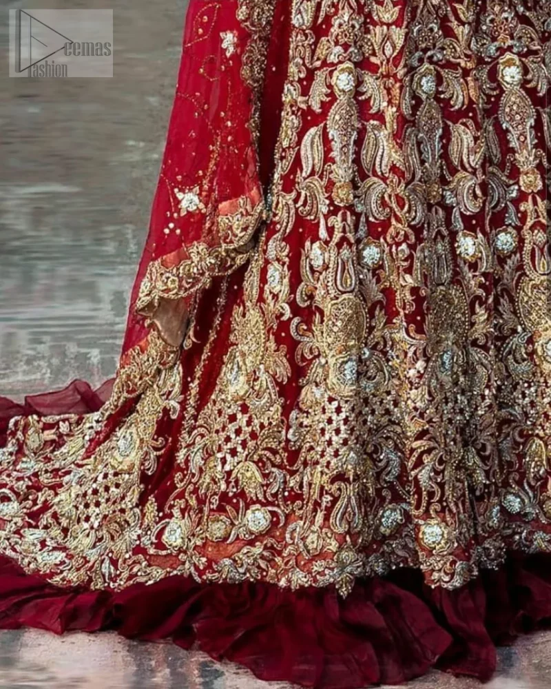 Red Ruffled Back Train Lehenga Blouse – Dupatta. A red half-sleeved traditional Blouse Choli that is exceptionally made with pure organza, styled artistically with a back train, followed by a criss-cross patterned Lehenga and a blouse exquisitely designed with gota work.