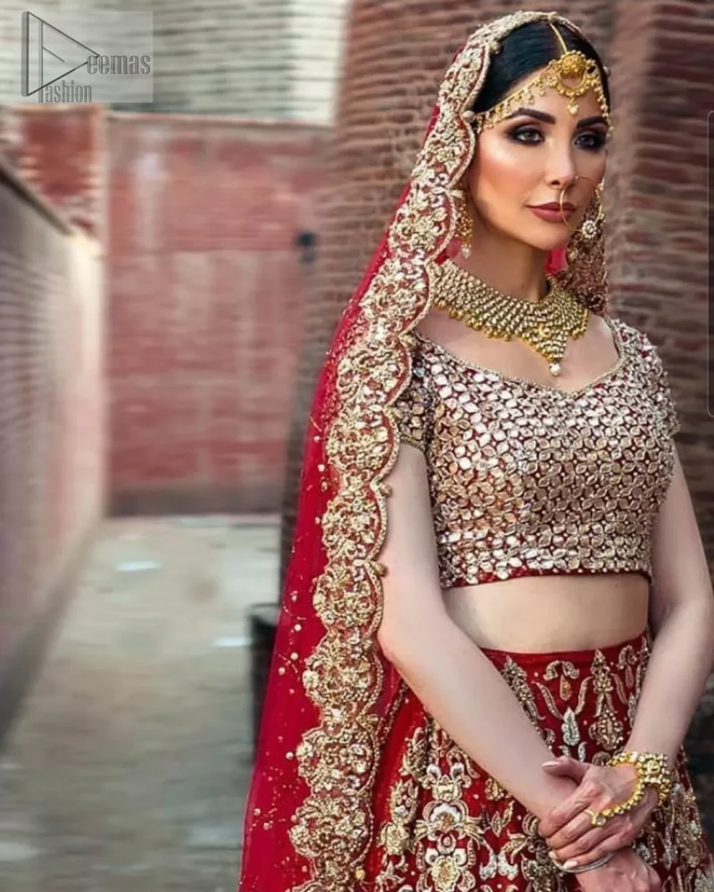 A red half-sleeved traditional Blouse Choli that is exceptionally made with pure organza, styled artistically with a back train, followed by a criss-cross patterned Lehenga and a blouse exquisitely designed with gota work. Red Ruffled Back Train Lehenga Blouse – Dupatta.