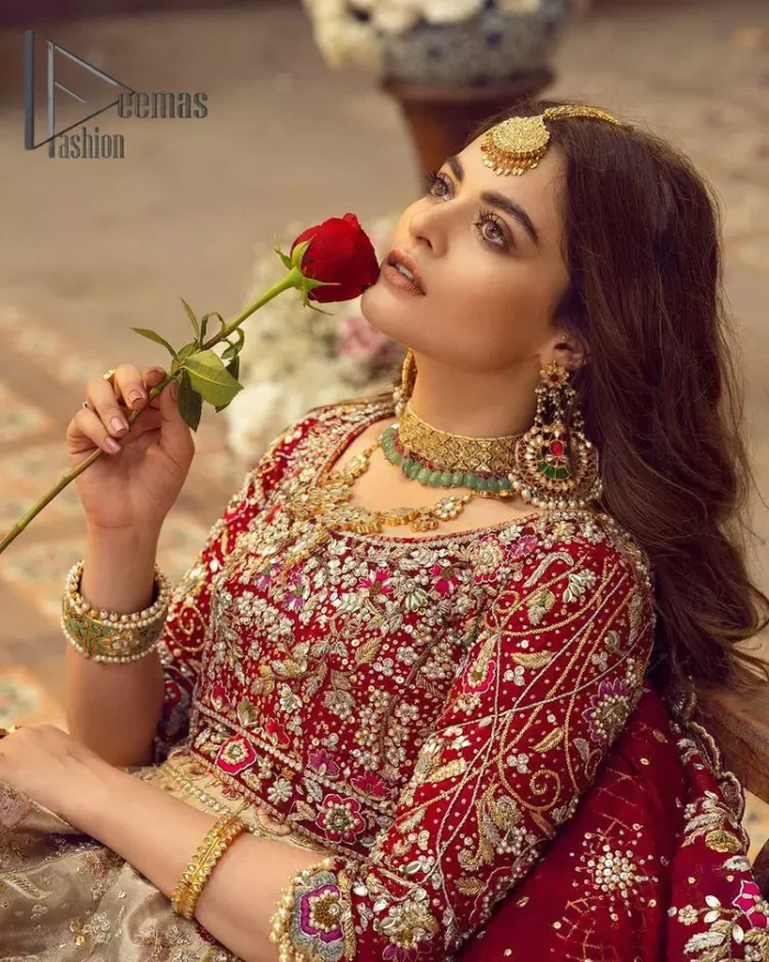 It's distinctive how the new-gen brides are welcoming red and beige shades for their bridal outfits as well. So Welcome your guest to this charming beige lehenga. The three quarter-sleeved Red Blouse  got it all for you. In addition to this, the Beige lehenga have embellished border embroidery and floral embroidery in dabka, kora work that give the stunning look. Furthermore, it is enhanced with embroidered applique bottom. The organza red dupatta that has a scalloped applique border all around the edges makes the look complete and comprehensive.