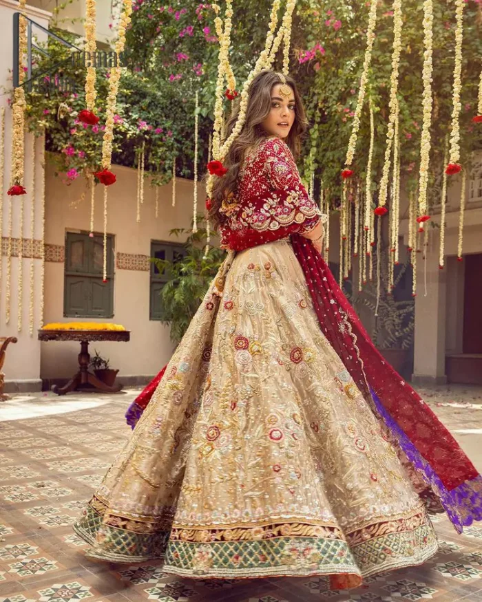 It's distinctive how the new-gen brides are welcoming red and beige shades for their bridal outfits as well. So Welcome your guest to this charming beige lehenga. The three quarter-sleeved Red Blouse  got it all for you. In addition to this, the Beige lehenga have embellished border embroidery and floral embroidery in dabka, kora work that give the stunning look. Furthermore, it is enhanced with embroidered applique bottom. The organza red dupatta that has a scalloped applique border all around the edges makes the look complete and comprehensive.