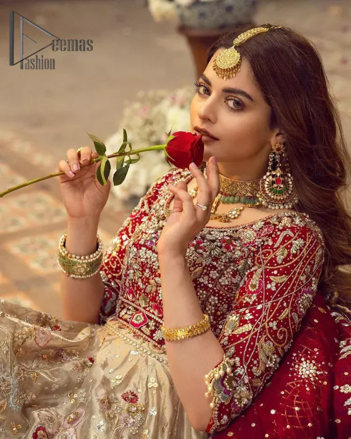 It's distinctive how the new-gen brides are welcoming red and beige shades for their bridal outfits as well. So Welcome your guest to this charming beige lehenga. The three quarter-sleeved Red Blouse  got it all for you. In addition to this, the Beige lehenga have embellished border embroidery and floral embroidery in dabka, kora work that give the stunning look. Furthermore, it is enhanced with embroidered applique bottom. The organza red dupatta that has a scalloped applique border all around the edges makes the look complete and comprehensive.
