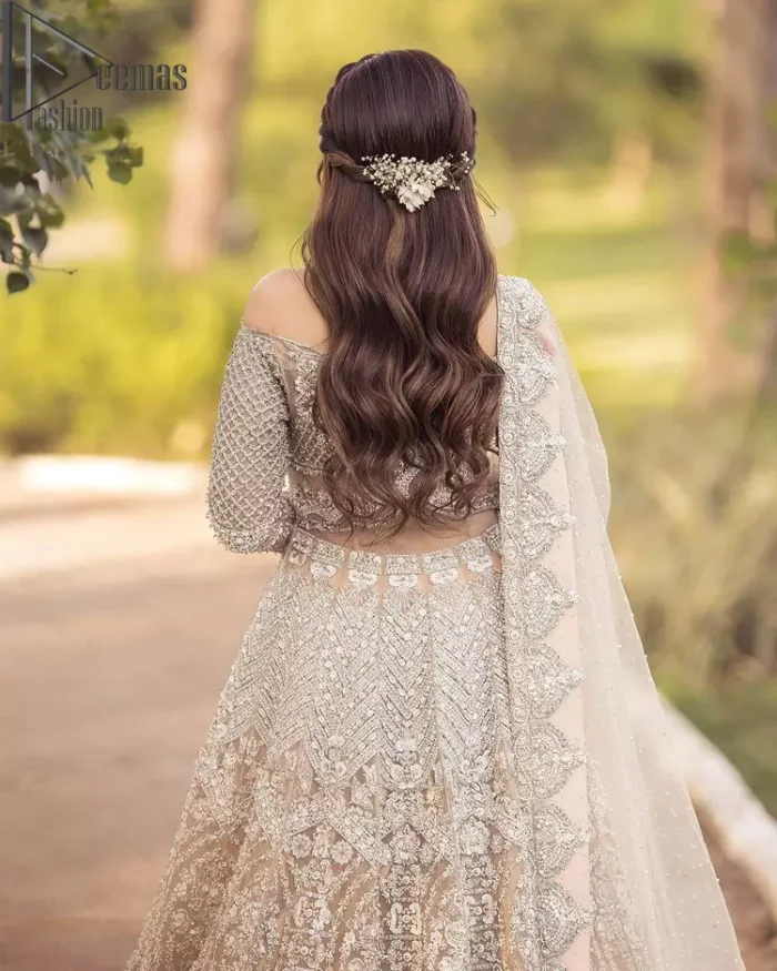 If you believed in mythical stories, shared all your secrets with glorious fairies and want to look like that mythical fairy on your reception then this Beige article is for you. This off-shoulder maxi is beautifully embellished with kora, dabka, tilla, sequins and pearls work, style up with remarkable full sleeves. Introducing this with a ruffled lehenga that looks super stunning and priceless. Followed with a net dupatta that is prominent with hand embellished borders and sequins spray all over that enhances the beauty of the outfit and give you a mythical fairy look as well.