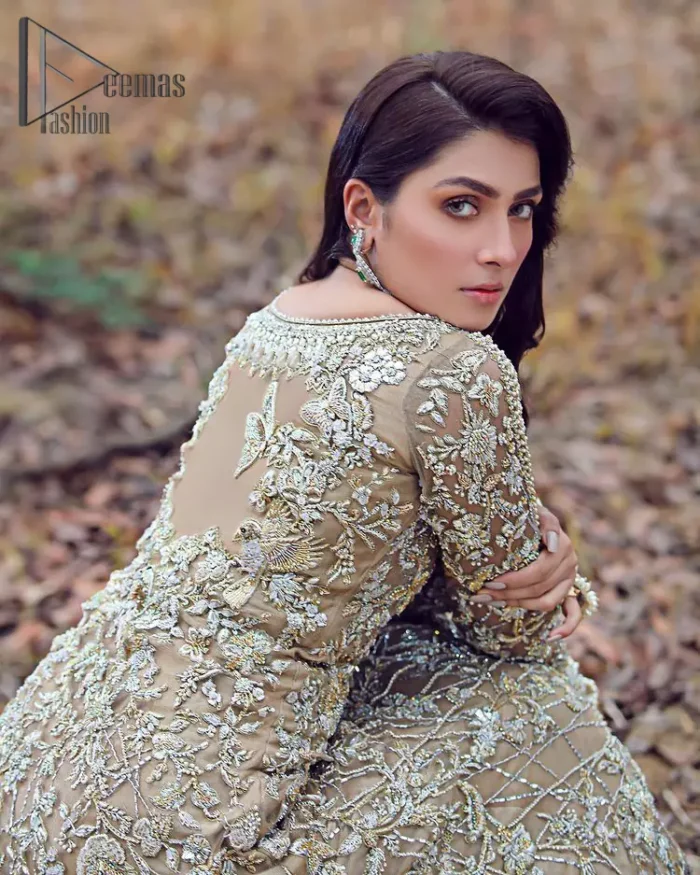 Fawn tunes for the reception? Hell Yes So just glow like a diamond with the Fawn Back Train Maxi, a delightful full-sleeves bridal wear with a unique splendid illusion neck, making you the particular queen of the event. The bottom ruffling of maxi is in super contrast with a dupatta that looks gorgeous. Dupatta has its own grace here with this splendid outfit too in fawn colour with organza fabric and large coverage area with a heavy appearance of floral motifs.