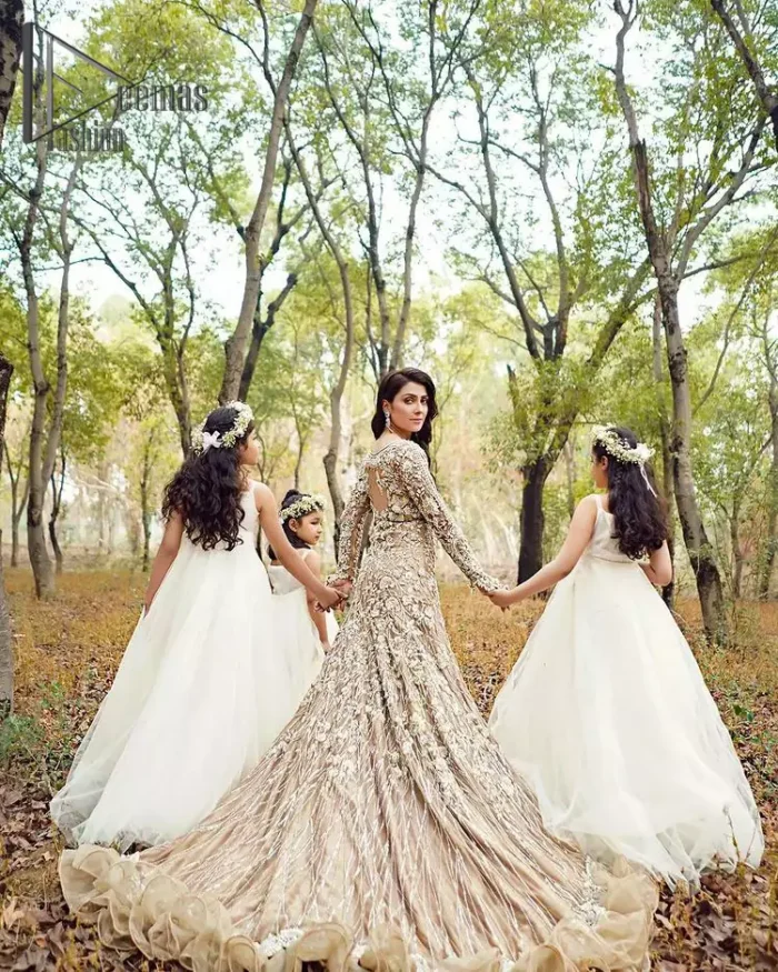 Fawn tunes for the reception? Hell Yes So just glow like a diamond with the Fawn Back Train Maxi, a delightful full-sleeves bridal wear with a unique splendid illusion neck, making you the particular queen of the event. The bottom ruffling of maxi is in super contrast with a dupatta that looks gorgeous. Dupatta has its own grace here with this splendid outfit too in fawn colour with organza fabric and large coverage area with a heavy appearance of floral motifs.