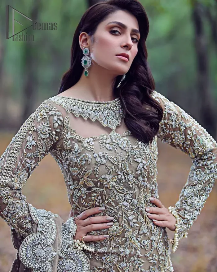 Fawn tunes for the reception? Hell Yes So just glow like a diamond with the Fawn Back Train Maxi, a delightful full-sleeves bridal wear with a unique splendid illusion neck, making you the particular queen of the event. The bottom ruffling of maxi is in super contrast with a dupatta that looks gorgeous. Dupatta has its own grace here with this splendid outfit too in fawn colour with organza fabric and large coverage area with a heavy appearance of floral motifs.