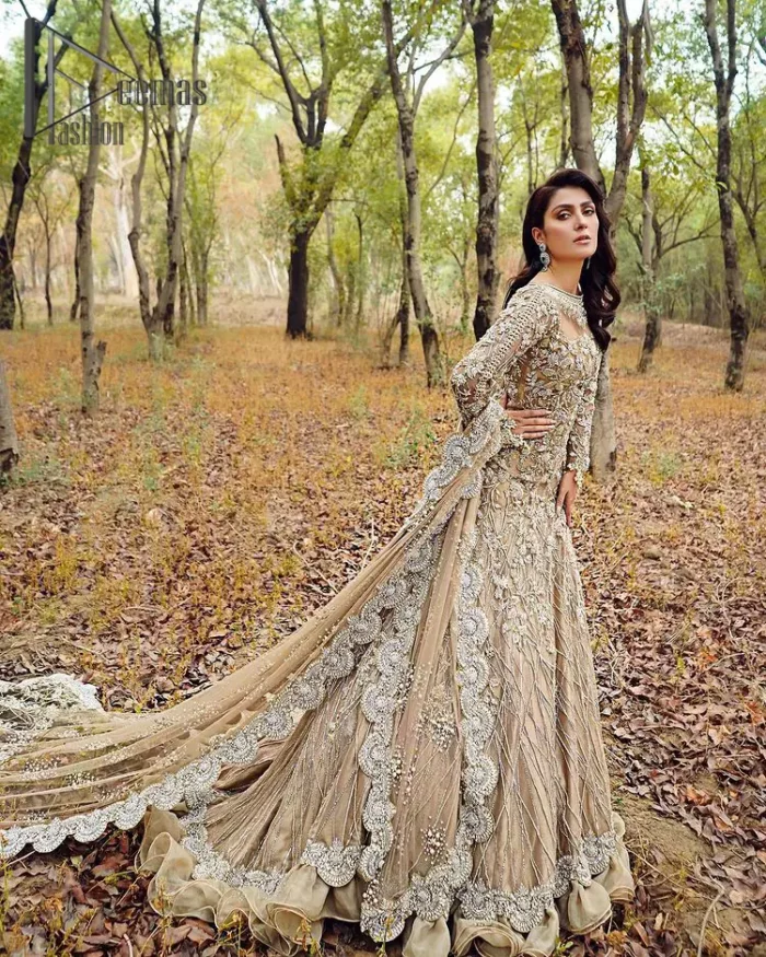 Fawn tunes for the reception? Hell Yes So just glow like a diamond with the Fawn Back Train Maxi, a delightful full-sleeves bridal wear with a unique splendid illusion neck, making you the particular queen of the event. The bottom ruffling of maxi is in super contrast with a dupatta that looks gorgeous. Dupatta has its own grace here with this splendid outfit too in fawn colour with organza fabric and large coverage area with a heavy appearance of floral motifs.