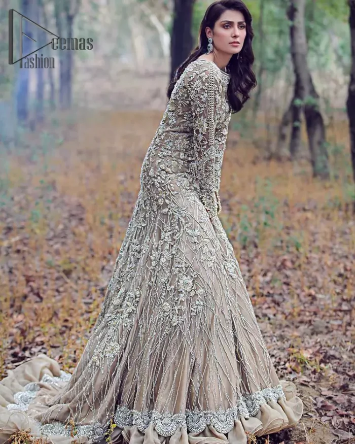 Fawn tunes for the reception? Hell Yes So just glow like a diamond with the Fawn Back Train Maxi, a delightful full-sleeves bridal wear with a unique splendid illusion neck, making you the particular queen of the event. The bottom ruffling of maxi is in super contrast with a dupatta that looks gorgeous. Dupatta has its own grace here with this splendid outfit too in fawn colour with organza fabric and large coverage area with a heavy appearance of floral motifs.