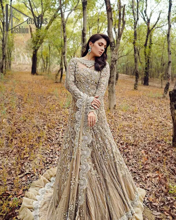Fawn tunes for the reception? Hell Yes So just glow like a diamond with the Fawn Back Train Maxi, a delightful full-sleeves bridal wear with a unique splendid illusion neck, making you the particular queen of the event. The bottom ruffling of maxi is in super contrast with a dupatta that looks gorgeous. Dupatta has its own grace here with this splendid outfit too in fawn colour with organza fabric and large coverage area with a heavy appearance of floral motifs.