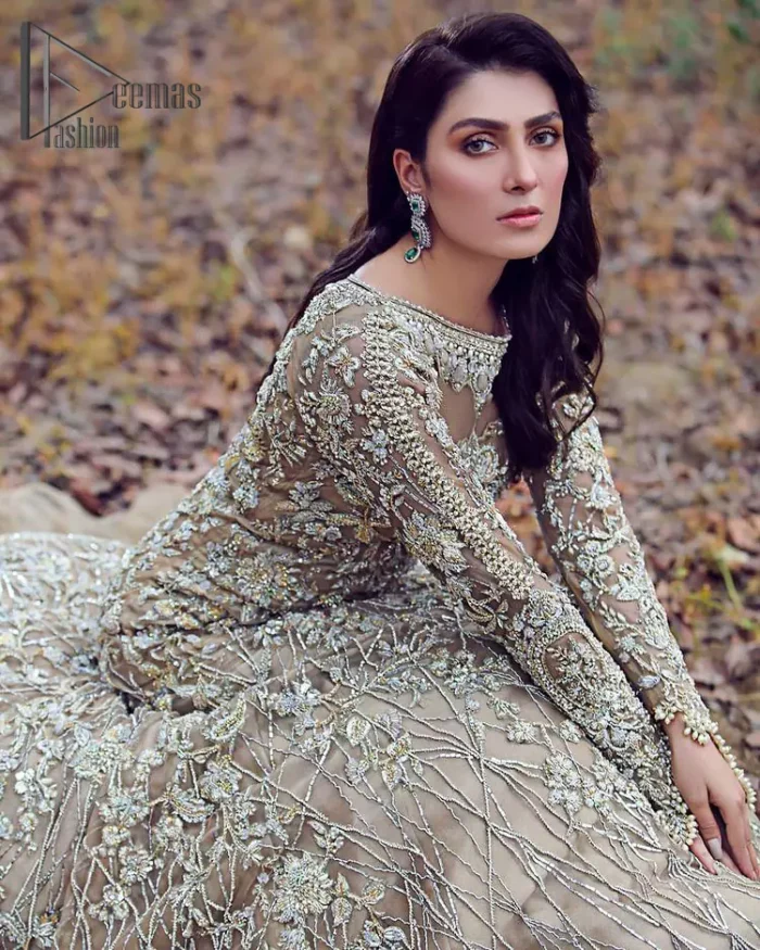 Fawn tunes for the reception? Hell Yes So just glow like a diamond with the Fawn Back Train Maxi, a delightful full-sleeves bridal wear with a unique splendid illusion neck, making you the particular queen of the event. The bottom ruffling of maxi is in super contrast with a dupatta that looks gorgeous. Dupatta has its own grace here with this splendid outfit too in fawn colour with organza fabric and large coverage area with a heavy appearance of floral motifs.