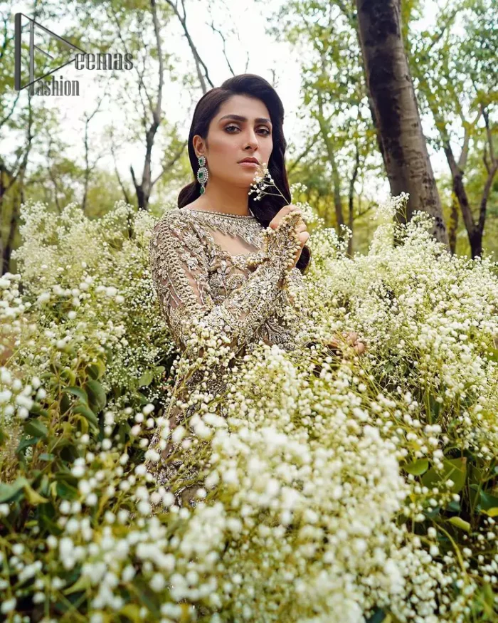 Fawn tunes for the reception? Hell Yes So just glow like a diamond with the Fawn Back Train Maxi, a delightful full-sleeves bridal wear with a unique splendid illusion neck, making you the particular queen of the event. The bottom ruffling of maxi is in super contrast with a dupatta that looks gorgeous. Dupatta has its own grace here with this splendid outfit too in fawn colour with organza fabric and large coverage area with a heavy appearance of floral motifs.