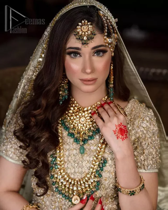 Nothing seems more promising than a Light Fawn colour for your big day. So, entertain your day with this outstanding half sleeve fawn blouse that is embellished with zardozi work. Comes up with a lehenga that is adorned with sequins, pearls and golden embroidery and large floral motifs scattered on blooming and stunning back train. Finish this look with a dupatta embellished with a four-sided border and sequins spray all over just to give you a delightful and promising look on your big day.