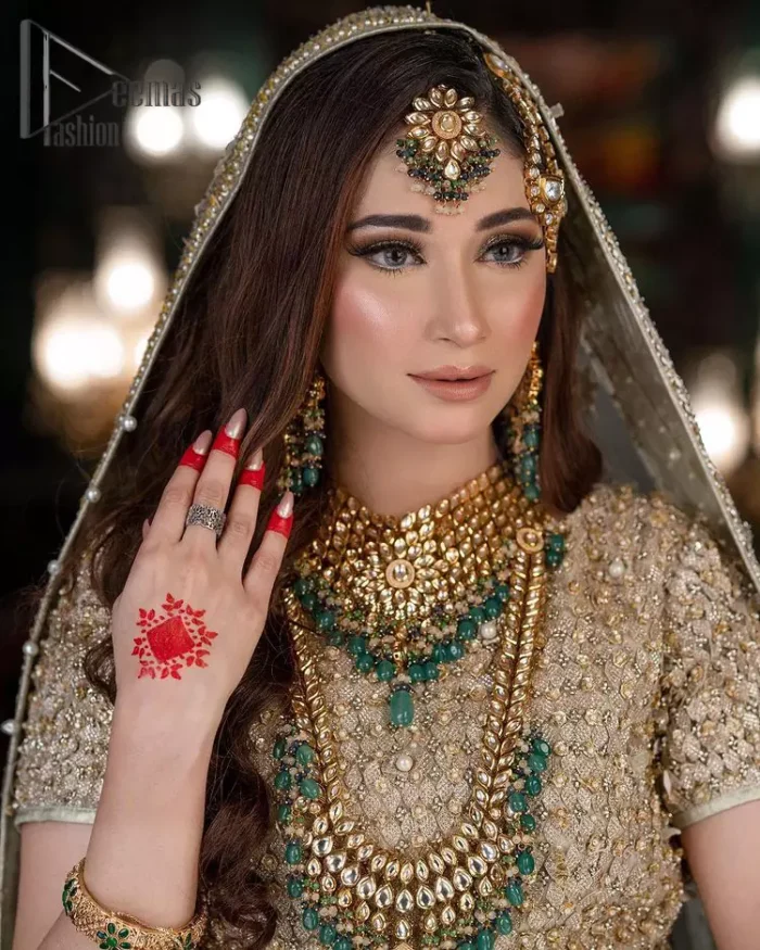 Nothing seems more promising than a Light Fawn colour for your big day. So, entertain your day with this outstanding half sleeve fawn blouse that is embellished with zardozi work. Comes up with a lehenga that is adorned with sequins, pearls and golden embroidery and large floral motifs scattered on blooming and stunning back train. Finish this look with a dupatta embellished with a four-sided border and sequins spray all over just to give you a delightful and promising look on your big day.