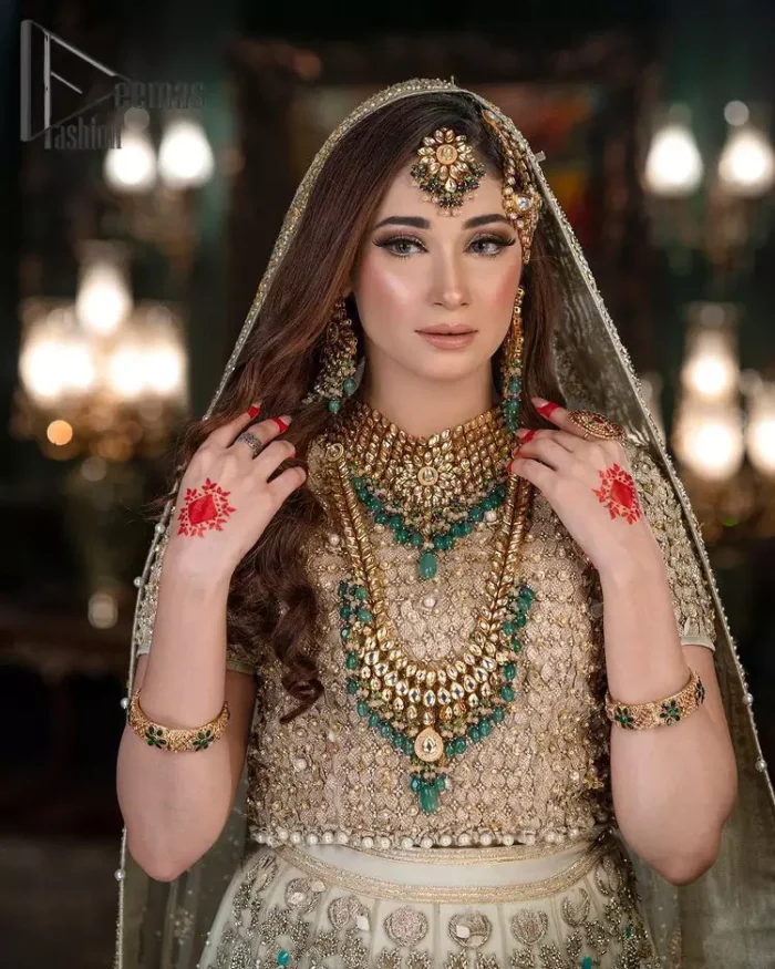 Nothing seems more promising than a Light Fawn colour for your big day. So, entertain your day with this outstanding half sleeve fawn blouse that is embellished with zardozi work. Comes up with a lehenga that is adorned with sequins, pearls and golden embroidery and large floral motifs scattered on blooming and stunning back train. Finish this look with a dupatta embellished with a four-sided border and sequins spray all over just to give you a delightful and promising look on your big day.