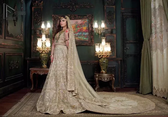 Nothing seems more promising than a Light Fawn colour for your big day. So, entertain your day with this outstanding half sleeve fawn blouse that is embellished with zardozi work. Comes up with a lehenga that is adorned with sequins, pearls and golden embroidery and large floral motifs scattered on blooming and stunning back train. Finish this look with a dupatta embellished with a four-sided border and sequins spray all over just to give you a delightful and promising look on your big day.