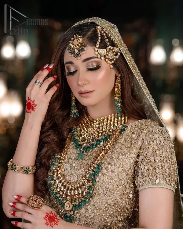 Nothing seems more promising than a Light Fawn colour for your big day. So, entertain your day with this outstanding half sleeve fawn blouse that is embellished with zardozi work. Comes up with a lehenga that is adorned with sequins, pearls and golden embroidery and large floral motifs scattered on blooming and stunning back train. Finish this look with a dupatta embellished with a four-sided border and sequins spray all over just to give you a delightful and promising look on your big day.