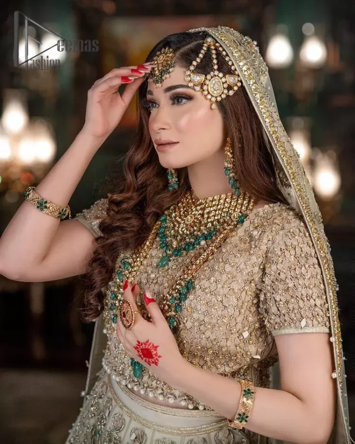Nothing seems more promising than a Light Fawn colour for your big day. So, entertain your day with this outstanding half sleeve fawn blouse that is embellished with zardozi work. Comes up with a lehenga that is adorned with sequins, pearls and golden embroidery and large floral motifs scattered on blooming and stunning back train. Finish this look with a dupatta embellished with a four-sided border and sequins spray all over just to give you a delightful and promising look on your big day.