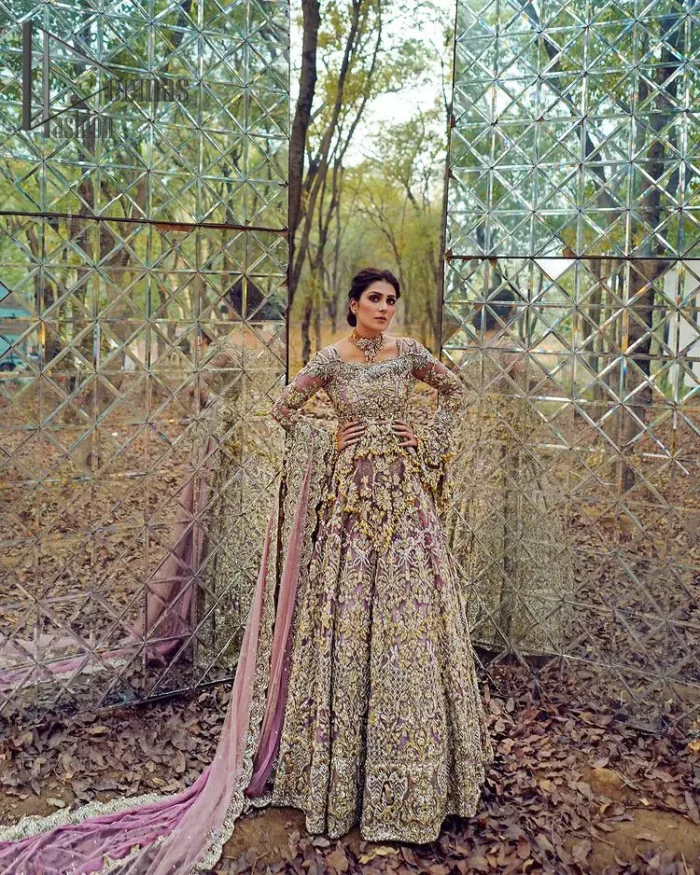 Celebrating the joy of togetherness with the light purple outfit. Grace is symbolized when it gets paired up with a light purple dupatta having a golden border and applique finishing all around the edges. The frilled sleeves of this peplum look stunning with its sweetheart neckline.  The bottom of the peplum is emphasized with an elegant arrangement of floral bunches and layer patterns. Accompanied by a matching lehenga decorated with golden zardozi work so that bride looks super-duper gorgeous on her walima day.