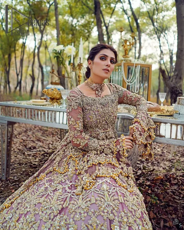 Celebrating the joy of togetherness with the light purple outfit. Grace is symbolized when it gets paired up with a light purple dupatta having a golden border and applique finishing all around the edges. The frilled sleeves of this peplum look stunning with its sweetheart neckline.  The bottom of the peplum is emphasized with an elegant arrangement of floral bunches and layer patterns. Accompanied by a matching lehenga decorated with golden zardozi work so that bride looks super-duper gorgeous on her walima day.