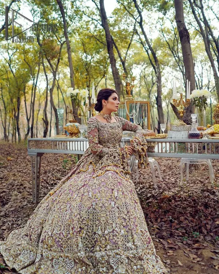 Celebrating the joy of togetherness with the light purple outfit. Grace is symbolized when it gets paired up with a light purple dupatta having a golden border and applique finishing all around the edges. The frilled sleeves of this peplum look stunning with its sweetheart neckline.  The bottom of the peplum is emphasized with an elegant arrangement of floral bunches and layer patterns. Accompanied by a matching lehenga decorated with golden zardozi work so that bride looks super-duper gorgeous on her walima day.