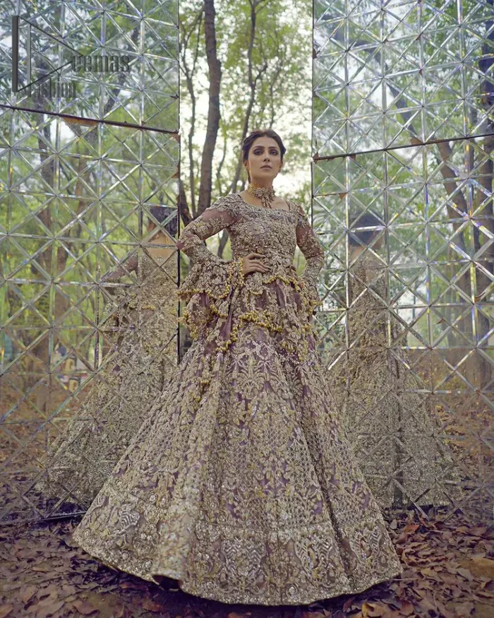Celebrating the joy of togetherness with the light purple outfit. Grace is symbolized when it gets paired up with a light purple dupatta having a golden border and applique finishing all around the edges. The frilled sleeves of this peplum look stunning with its sweetheart neckline.  The bottom of the peplum is emphasized with an elegant arrangement of floral bunches and layer patterns. Accompanied by a matching lehenga decorated with golden zardozi work so that bride looks super-duper gorgeous on her walima day.