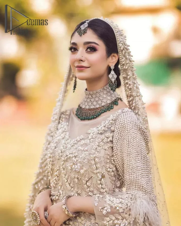 Nothing shines out more than a bride in her most natural state. For the Love of Ivory, this outfit was originally made in the shade of ivory to match the modern look in reception. This full sleeves ivory maxi is just decorated with 3D handsome flowers, style up with pearls embroidery and boat shape illusion neckline. Furthermore, the back train of this maxi gives you a super dazzling look on your reception day. Pair it up with the same colour dupatta made with pure net and embellished with a four-sided border to glamourous and enhance the combination.