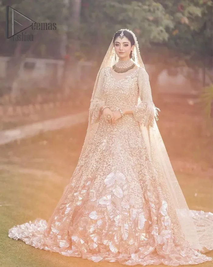 Nothing shines out more than a bride in her most natural state. For the Love of Ivory, this outfit was originally made in the shade of ivory to match the modern look in reception. This full sleeves ivory maxi is just decorated with 3D handsome flowers, style up with pearls embroidery and boat shape illusion neckline. Furthermore, the back train of this maxi gives you a super dazzling look on your reception day. Pair it up with the same colour dupatta made with pure net and embellished with a four-sided border to glamourous and enhance the combination.