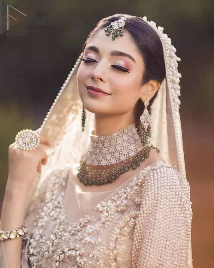 Nothing shines out more than a bride in her most natural state. For the Love of Ivory, this outfit was originally made in the shade of ivory to match the modern look in reception. This full sleeves ivory maxi is just decorated with 3D handsome flowers, style up with pearls embroidery and boat shape illusion neckline. Furthermore, the back train of this maxi gives you a super dazzling look on your reception day. Pair it up with the same colour dupatta made with pure net and embellished with a four-sided border to glamourous and enhance the combination.