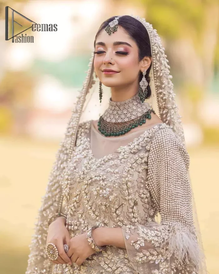 Nothing shines out more than a bride in her most natural state. For the Love of Ivory, this outfit was originally made in the shade of ivory to match the modern look in reception. This full sleeves ivory maxi is just decorated with 3D handsome flowers, style up with pearls embroidery and boat shape illusion neckline. Furthermore, the back train of this maxi gives you a super dazzling look on your reception day. Pair it up with the same colour dupatta made with pure net and embellished with a four-sided border to glamourous and enhance the combination.