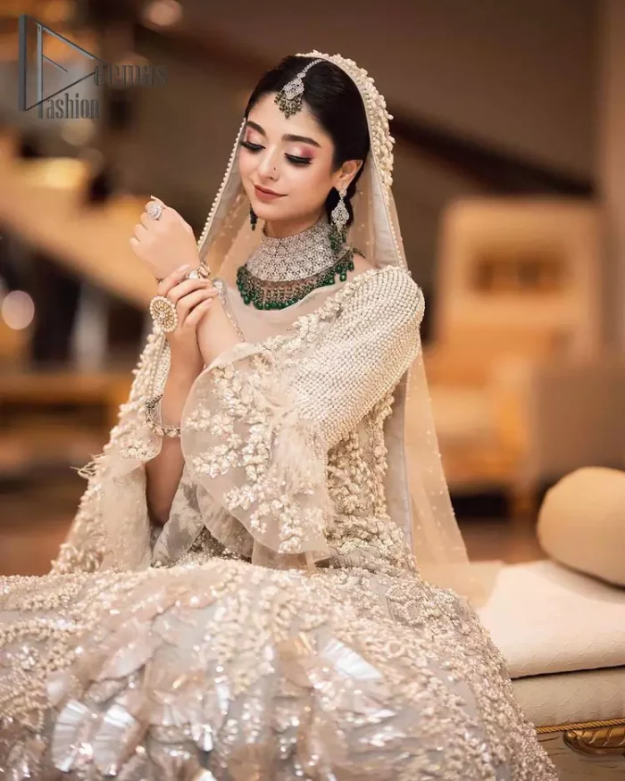 Nothing shines out more than a bride in her most natural state. For the Love of Ivory, this outfit was originally made in the shade of ivory to match the modern look in reception. This full sleeves ivory maxi is just decorated with 3D handsome flowers, style up with pearls embroidery and boat shape illusion neckline. Furthermore, the back train of this maxi gives you a super dazzling look on your reception day. Pair it up with the same colour dupatta made with pure net and embellished with a four-sided border to glamourous and enhance the combination.