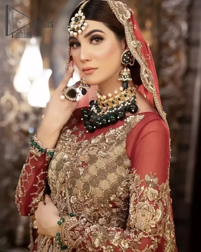 Take your style up a few notches with this bold yet elegant piece on your Big day. This red full sleeves habitual blouse choli is remarkably made with pure organza, styled easily and graciously with boat shape neckline and fully embellished with tilla, kora , dabka work. In addition to this, the frilled lehenga is also fully embellished with heavy embroidery that perfectly enhance your dazzling style on your big day. Finish this look with a red dupatta that have sequins spray all around and embellished with a four-sided scalloped border as well.