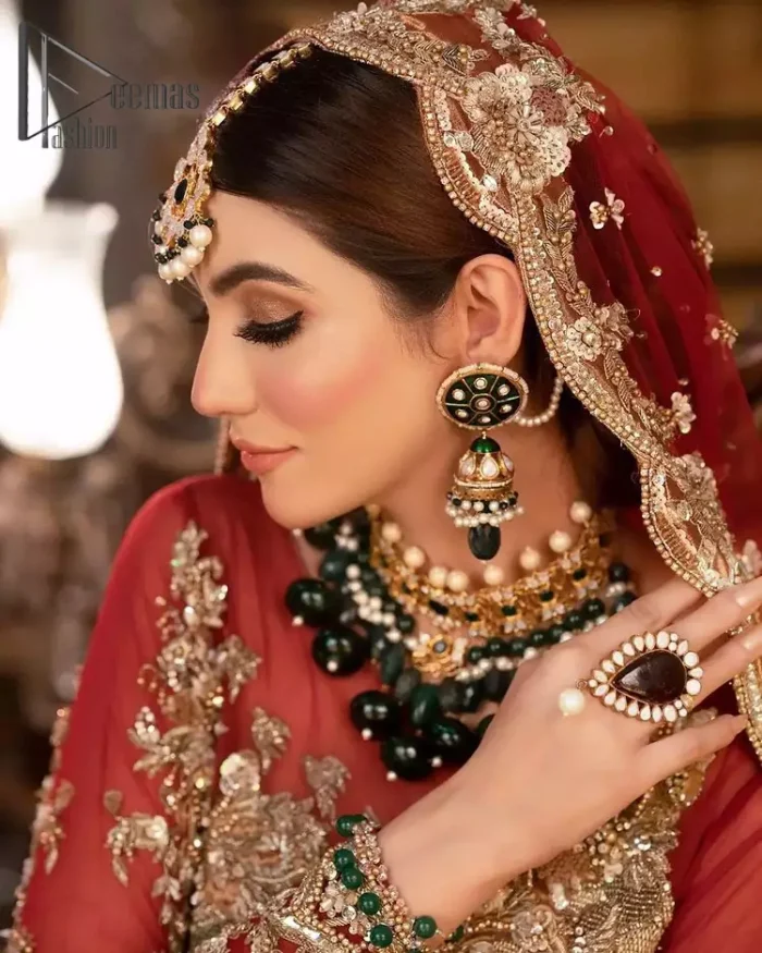 Take your style up a few notches with this bold yet elegant piece on your Big day. This red full sleeves habitual blouse choli is remarkably made with pure organza, styled easily and graciously with boat shape neckline and fully embellished with tilla, kora , dabka work. In addition to this, the frilled lehenga is also fully embellished with heavy embroidery that perfectly enhance your dazzling style on your big day. Finish this look with a red dupatta that have sequins spray all around and embellished with a four-sided scalloped border as well.