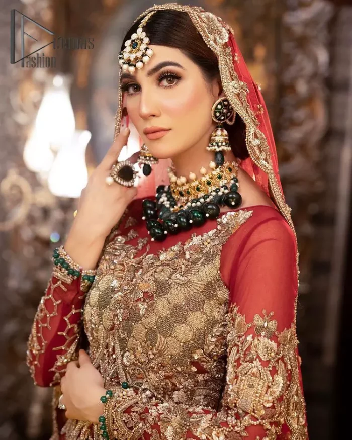 Take your style up a few notches with this bold yet elegant piece on your Big day. This red full sleeves habitual blouse choli is remarkably made with pure organza, styled easily and graciously with boat shape neckline and fully embellished with tilla, kora , dabka work. In addition to this, the frilled lehenga is also fully embellished with heavy embroidery that perfectly enhance your dazzling style on your big day. Finish this look with a red dupatta that have sequins spray all around and embellished with a four-sided scalloped border as well.