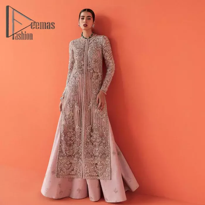 If you have a galaxy in your eyes, and immense love in your heart for your outfits then this beautiful tea rose article is just for you. This full sleeves tea rose shirt is highlighted with kora, dabka and crystal embroidery. Furthermore, Its long open-front style is looking glamorous when it pairs up with the prettiest tea rose lehenga just embellished with tiny floral motifs that give you a super-duper fairy dreamy look on any special occasion. To finish the look, go with an organza dupatta decorated with sequins spray all over.
