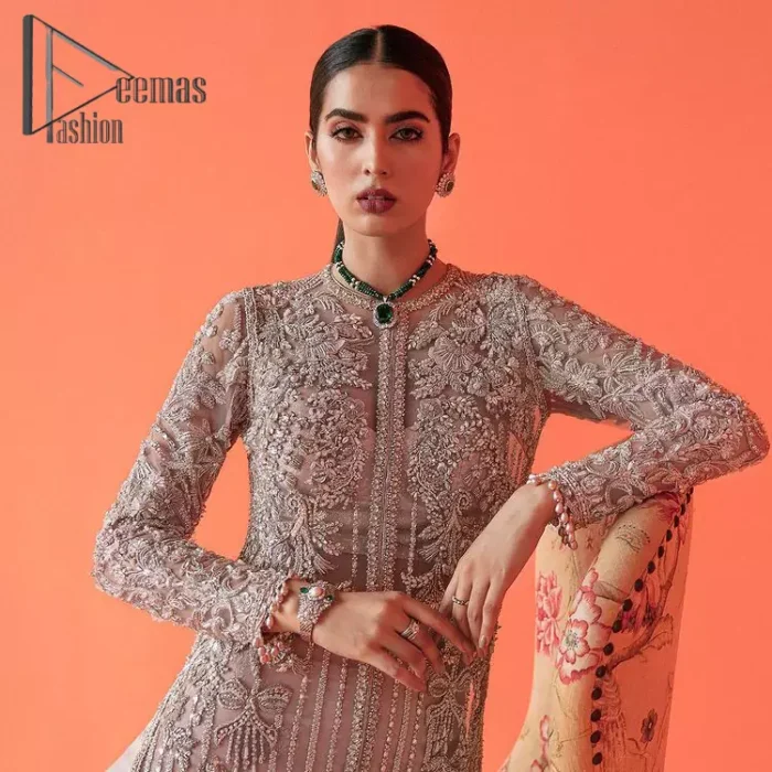 If you have a galaxy in your eyes, and immense love in your heart for your outfits then this beautiful tea rose article is just for you. This full sleeves tea rose shirt is highlighted with kora, dabka and crystal embroidery. Furthermore, Its long open-front style is looking glamorous when it pairs up with the prettiest tea rose lehenga just embellished with tiny floral motifs that give you a super-duper fairy dreamy look on any special occasion. To finish the look, go with an organza dupatta decorated with sequins spray all over.