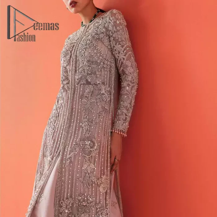 If you have a galaxy in your eyes, and immense love in your heart for your outfits then this beautiful tea rose article is just for you. This full sleeves tea rose shirt is highlighted with kora, dabka and crystal embroidery. Furthermore, Its long open-front style is looking glamorous when it pairs up with the prettiest tea rose lehenga just embellished with tiny floral motifs that give you a super-duper fairy dreamy look on any special occasion. To finish the look, go with an organza dupatta decorated with sequins spray all over.