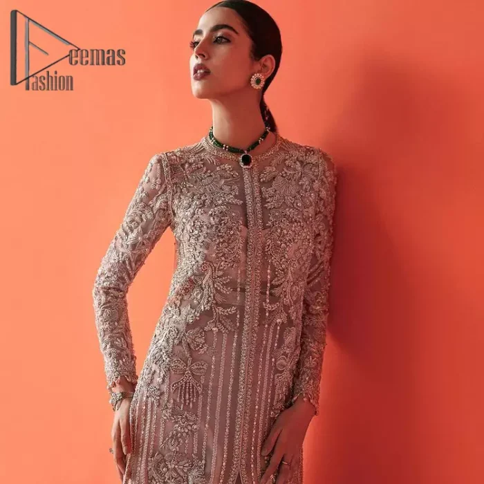 If you have a galaxy in your eyes, and immense love in your heart for your outfits then this beautiful tea rose article is just for you. This full sleeves tea rose shirt is highlighted with kora, dabka and crystal embroidery. Furthermore, Its long open-front style is looking glamorous when it pairs up with the prettiest tea rose lehenga just embellished with tiny floral motifs that give you a super-duper fairy dreamy look on any special occasion. To finish the look, go with an organza dupatta decorated with sequins spray all over.