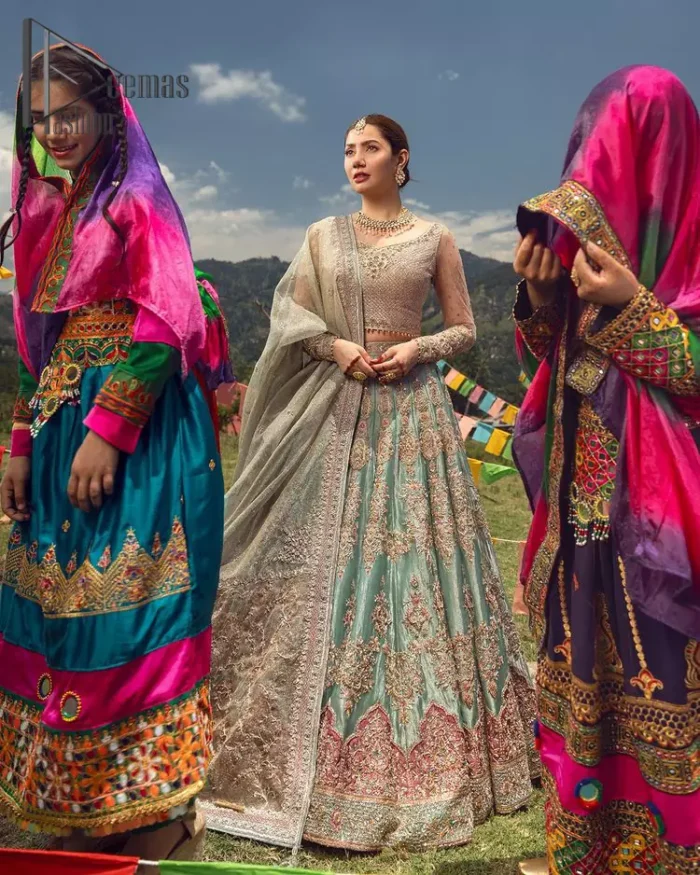 Talking about traditional, Deemas Fashion introduces the Aqua Lehenga and pink blouse which is an outstanding upgrade to bridal wear. This stunning full-sleeved attire presents an enchanting sweetheart neckline, embellished with the finest work of light golden embroidery, and adorned with pearls. This bridal wear has its own admiring look that comes with a tissue dupatta with embellished border. The Aqua colour of Lehenga gives so soothing look to the whole outfit. Furthermore, the lehenga is delicately adorned with golden kora, dabka, tilla, sequins and pearls embroidery. The border of the lehenga is also ornamented with embellished applique which gives the perfect ending to this outfit.