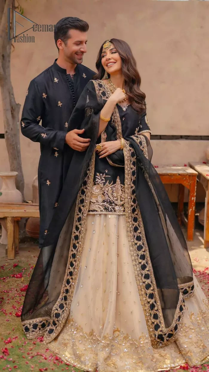 Do you want to feel like a superstar? So this stunning article is designed only for you. Just wear our black half sleeve short shirt embellished with kora, dabka and crystal work and fulfil your dream to feel like a superstar. Furthermore, It also comprises the beautiful, embellished border on the Daman. It is coordinated with a black net dupatta that is finished with geometric patterns on all four sides and comes with an Ivory can-can lehenga. The border of the lehenga is embellished with zardozi work giving a super aesthetic look to this artistic article.