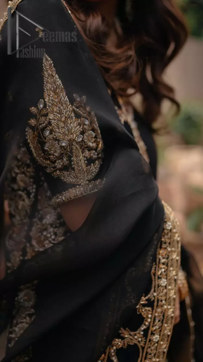 Do you want to feel like a superstar? So this stunning article is designed only for you. Just wear our black half sleeve short shirt embellished with kora, dabka and crystal work and fulfil your dream to feel like a superstar. Furthermore, It also comprises the beautiful, embellished border on the Daman. It is coordinated with a black net dupatta that is finished with geometric patterns on all four sides and comes with an Ivory can-can lehenga. The border of the lehenga is embellished with zardozi work giving a super aesthetic look to this artistic article.