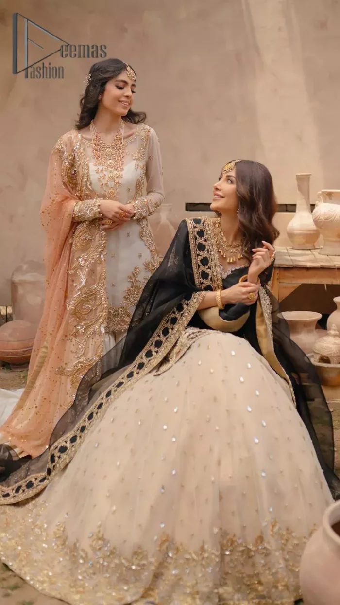 Do you want to feel like a superstar? So this stunning article is designed only for you. Just wear our black half sleeve short shirt embellished with kora, dabka and crystal work and fulfil your dream to feel like a superstar. Furthermore, It also comprises the beautiful, embellished border on the Daman. It is coordinated with a black net dupatta that is finished with geometric patterns on all four sides and comes with an Ivory can-can lehenga. The border of the lehenga is embellished with zardozi work giving a super aesthetic look to this artistic article.