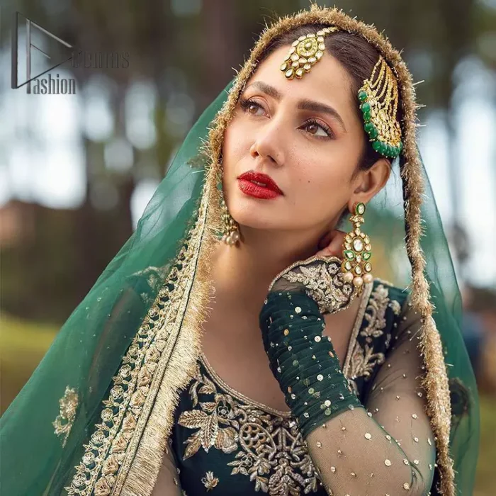 The eccentric Bottle Green outfit sings a melody just for you! The ghrara in bottle green is enriched with golden embroidery to create a modern vibe. This surprising full-sleeved shirt presents an outstanding sweetheart neckline, embellished with the finest work of golden and silver embroidery, and adorned with pearls while the details make it perfectly festive. Style it up with an organza dupatta which is sprinkled with sequins all over and four sides Kiran to give it a dreamy legal and royal look.