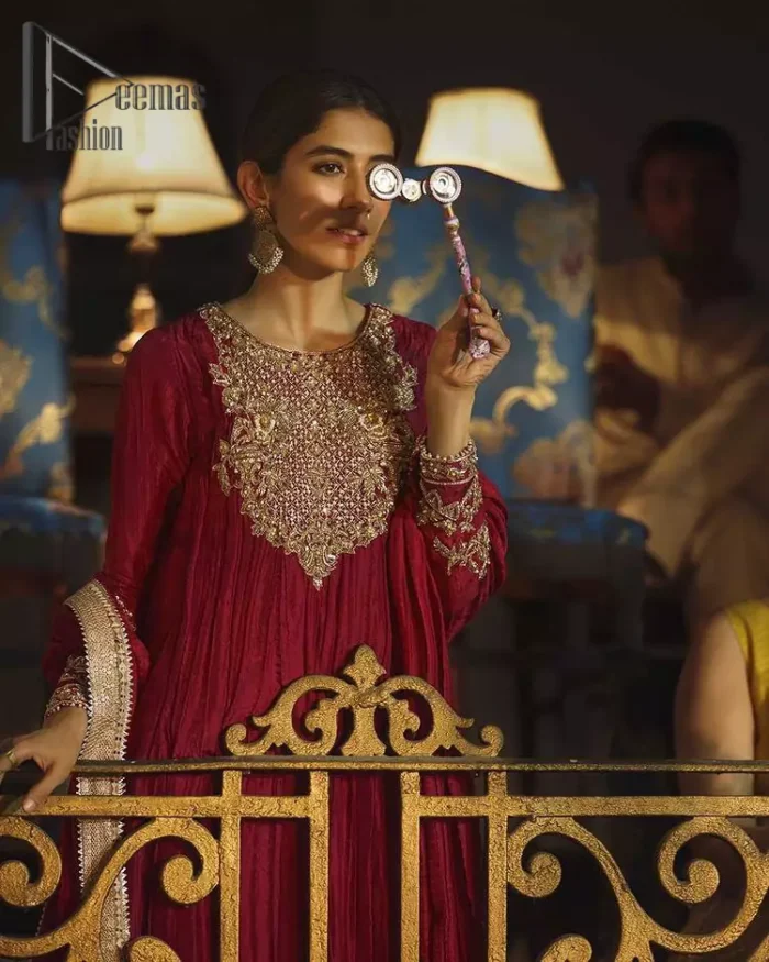 A picture of pure elegance with maroon crushed frock enhanced with embellished golden embroidered neckline. The neckline is adorned with golden kora, dabka and tilla work. Beautifully paired up with palazzo delicately crafted with embroidery on the border. With a lot of attention to detail, the intricate zardozi work using zardozi work and tilla makes the dress look like nothing but a dream. Dupatta is emphasized with lace all around the borders.