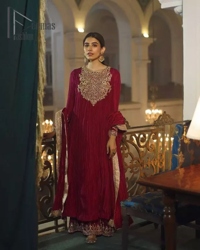 A picture of pure elegance with maroon crushed frock enhanced with embellished golden embroidered neckline. The neckline is adorned with golden kora, dabka and tilla work. Beautifully paired up with palazzo delicately crafted with embroidery on the border. With a lot of attention to detail, the intricate zardozi work using zardozi work and tilla makes the dress look like nothing but a dream. Dupatta is emphasized with lace all around the borders.