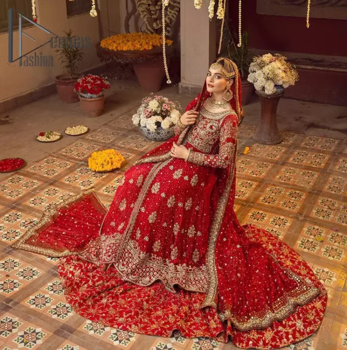 Some pieces are specifically hand-crafted to speak to your heart just like this red front open Pishwas. The pishwas with a boat-shaped neckline is adorned in luxuriously zardozi work with fabulous sparkle. The rest of the dress is beautifully crafted with floral motifs, sequins spray, and embroidered lines along the length. Set it up with a red  back train lehenga emphasized with kora, dabka, tilla and sequins work. Complete the look with an artfully coordinated dupatta having embellished sequins all over and scattered tiny floral motifs.