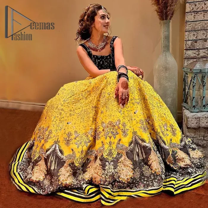 You smelled like sunshine and daisies when this pure magic wrapped around as our embroidery is luxurious. Yellow and black is the super trend of mehndi occasions. This eye-catching sleeveless black blouse having boat shape neckline looks priceless in silver and golden embroidery. In addition to this, yellow lehenga embellished with kora, dabka and sequins work and beautifully designed borders with zardozi, applique and Kiran shows the feeling of mehndi bride. Pair it up with a black dupatta that you would definitely want to wear for your next event.