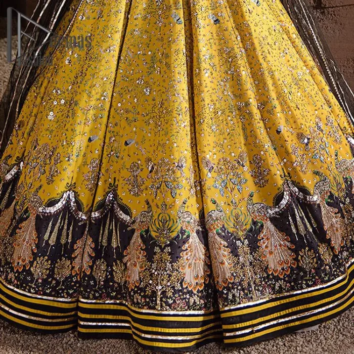 You smelled like sunshine and daisies when this pure magic wrapped around as our embroidery is luxurious. Yellow and black is the super trend of mehndi occasions. This eye-catching sleeveless black blouse having boat shape neckline looks priceless in silver and golden embroidery. In addition to this, yellow lehenga embellished with kora, dabka and sequins work and beautifully designed borders with zardozi, applique and Kiran shows the feeling of mehndi bride. Pair it up with a black dupatta that you would definitely want to wear for your next event.
