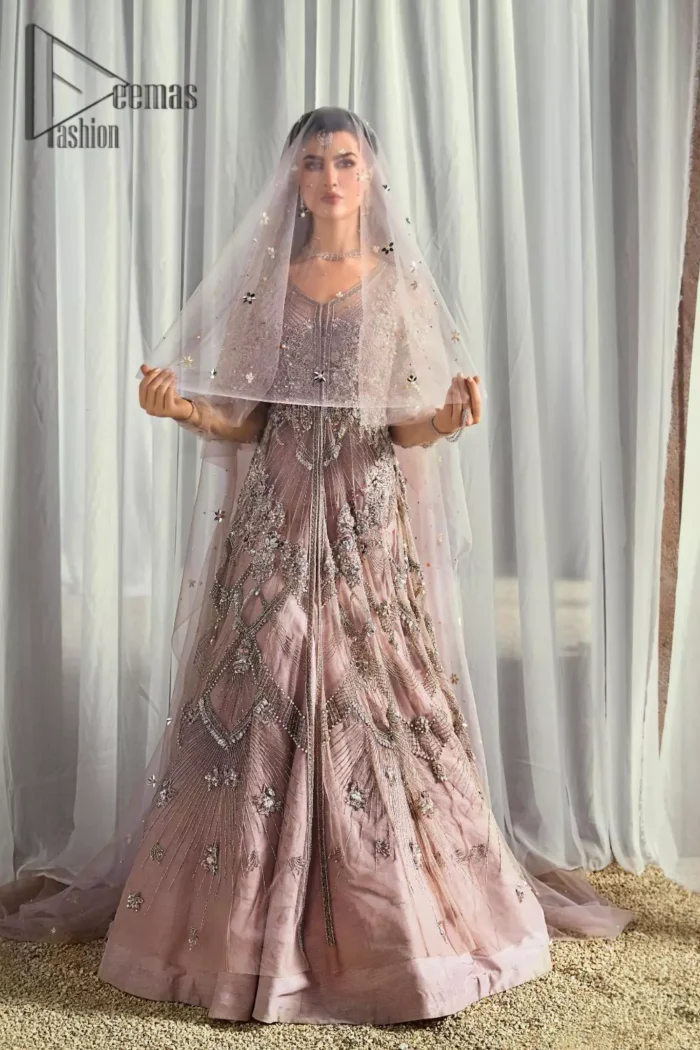 We like vibrance and sometimes you need a bit more vibrance to set the look. So, here we introduce a very vibrant tea pink front open maxi that embraces the season of festive. The maxi has a front open design embellished with crystal, kora, sequins work that serves with full sleeves and gives you a super-duper aesthetic look. Comes up with a fussed lehenga in the same colour. Finish this look with a tea pink net dupatta having sequins spray all over that increasing your dreamy vibrancy.