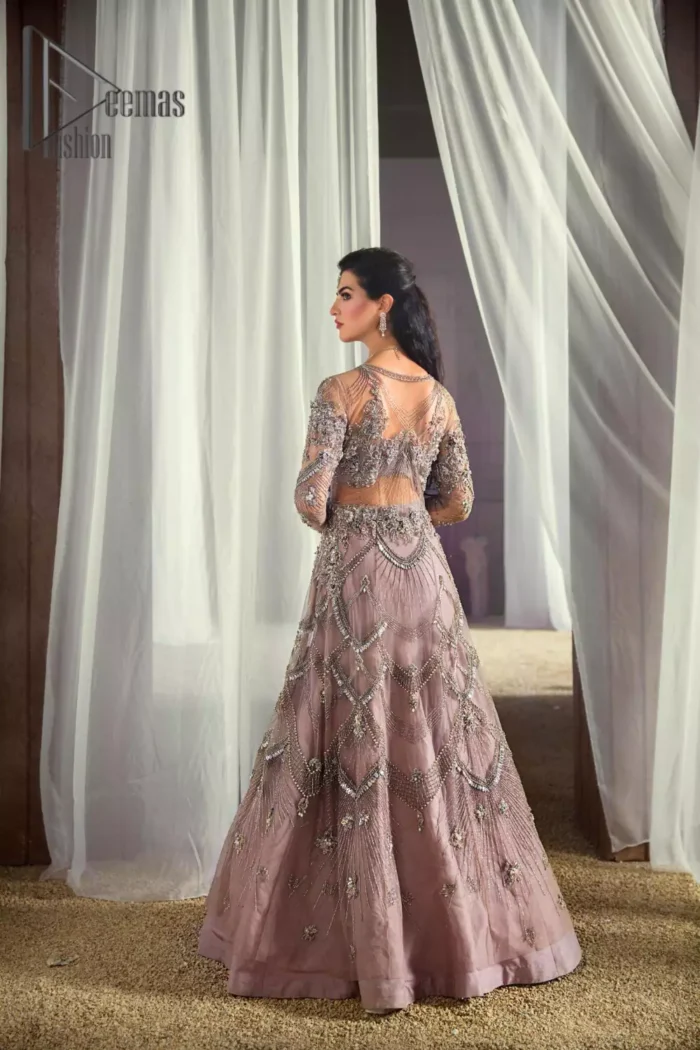 We like vibrance and sometimes you need a bit more vibrance to set the look. So, here we introduce a very vibrant tea pink front open maxi that embraces the season of festive. The maxi has a front open design embellished with crystal, kora, sequins work that serves with full sleeves and gives you a super-duper aesthetic look. Comes up with a fussed lehenga in the same colour. Finish this look with a tea pink net dupatta having sequins spray all over that increasing your dreamy vibrancy.