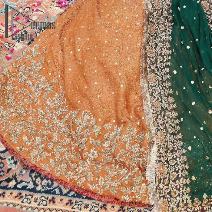 You have got plans for your mehndi? DeemasFashion got you to look!  Just go bold and bright with a beige blouse that is garnished with the same color thread embroidery and the blouse is highlighted with a square neckline and full sleeves. Further, the bottom of the blouse is adorned with red pearls that grant you a brilliant look. It is paired up with an orange lehenga that border is attractively enriched with golden embroidery and sequins spray all over. Finish this look with a green dupatta that is sprinkled with a four-sided Kiran and four sider border as well.
