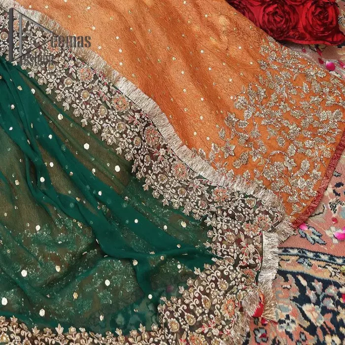 You have got plans for your mehndi? DeemasFashion got you to look!  Just go bold and bright with a beige blouse that is garnished with the same color thread embroidery and the blouse is highlighted with a square neckline and full sleeves. Further, the bottom of the blouse is adorned with red pearls that grant you a brilliant look. It is paired up with an orange lehenga that border is attractively enriched with golden embroidery and sequins spray all over. Finish this look with a green dupatta that is sprinkled with a four-sided Kiran and four sider border as well.